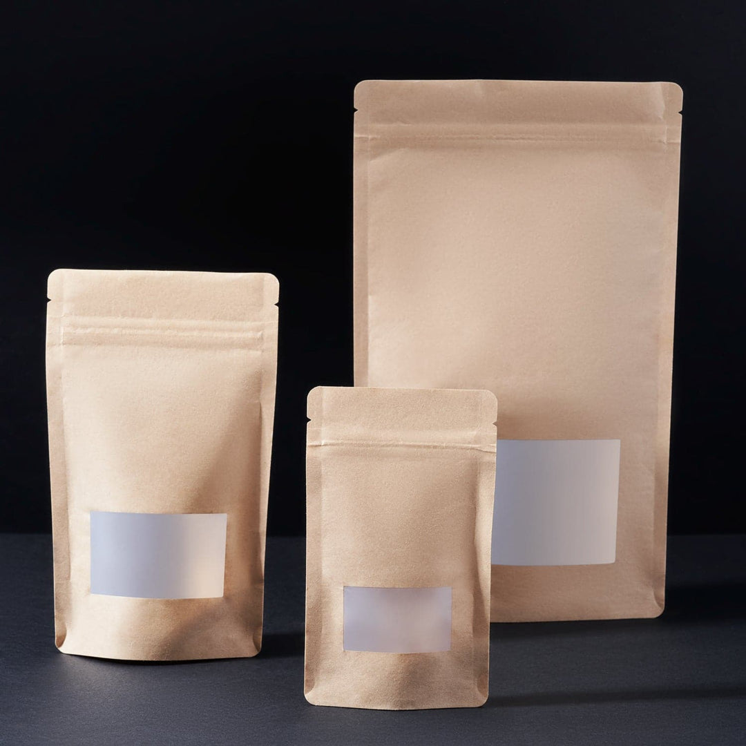 Stand Up Pouches with Window in three different sizes on a black background.