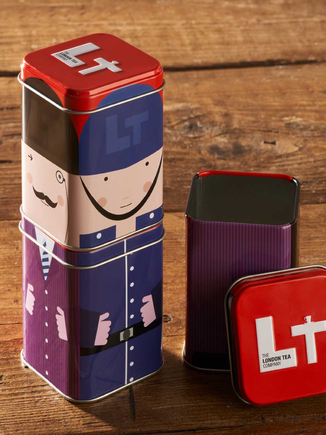 Bespoke tin packaging that stacks. There are three tins ins total each with a different part of a person and when stacked they make a whole person.