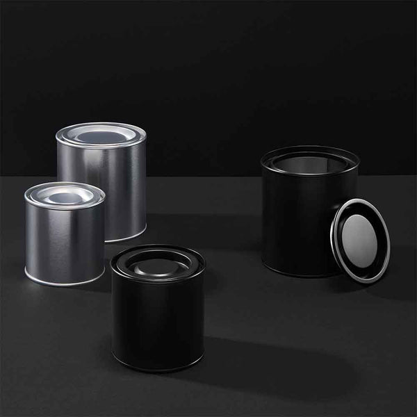 Collection of lever lid tins in black and silver on a black background