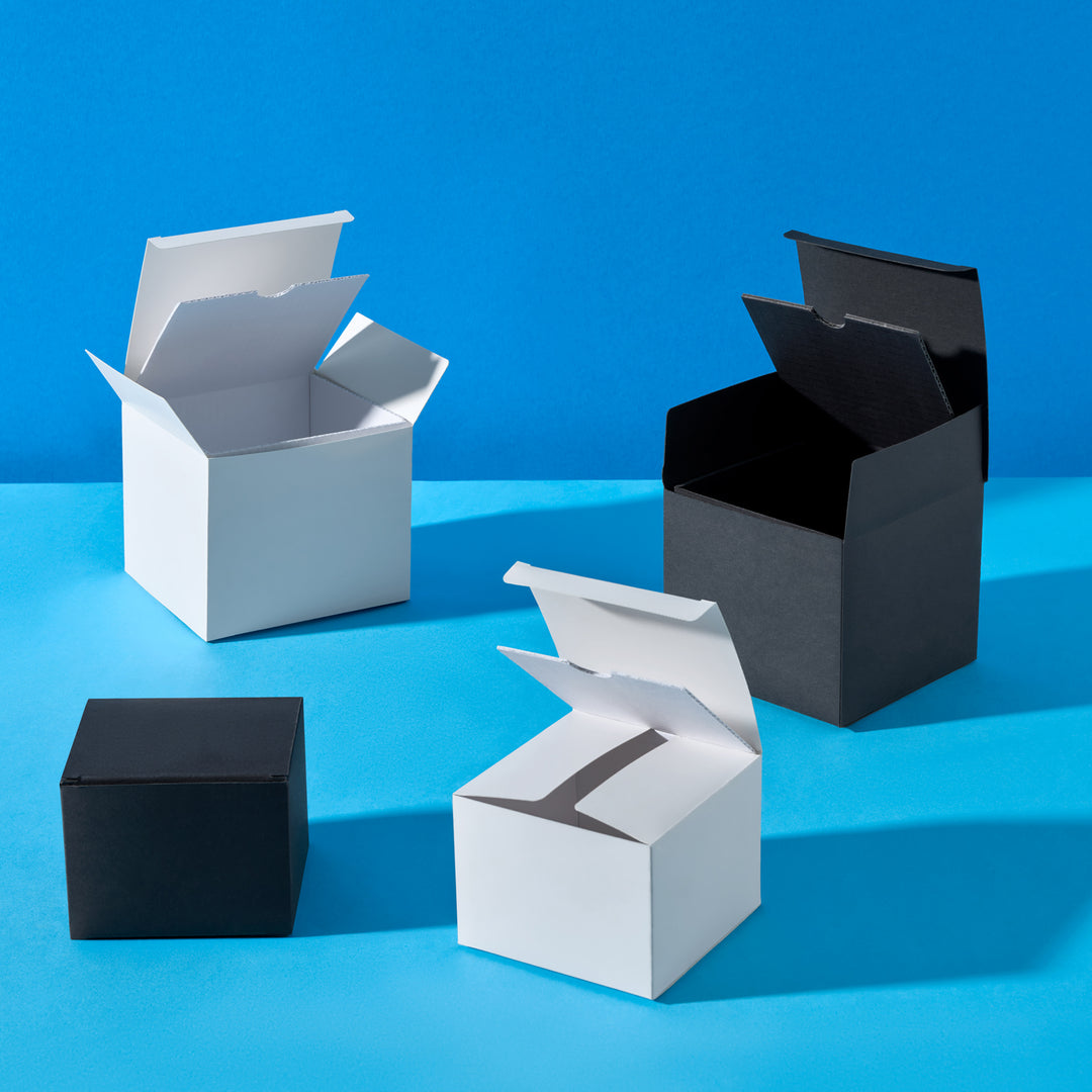 Four open boxes in black and white on a blue background