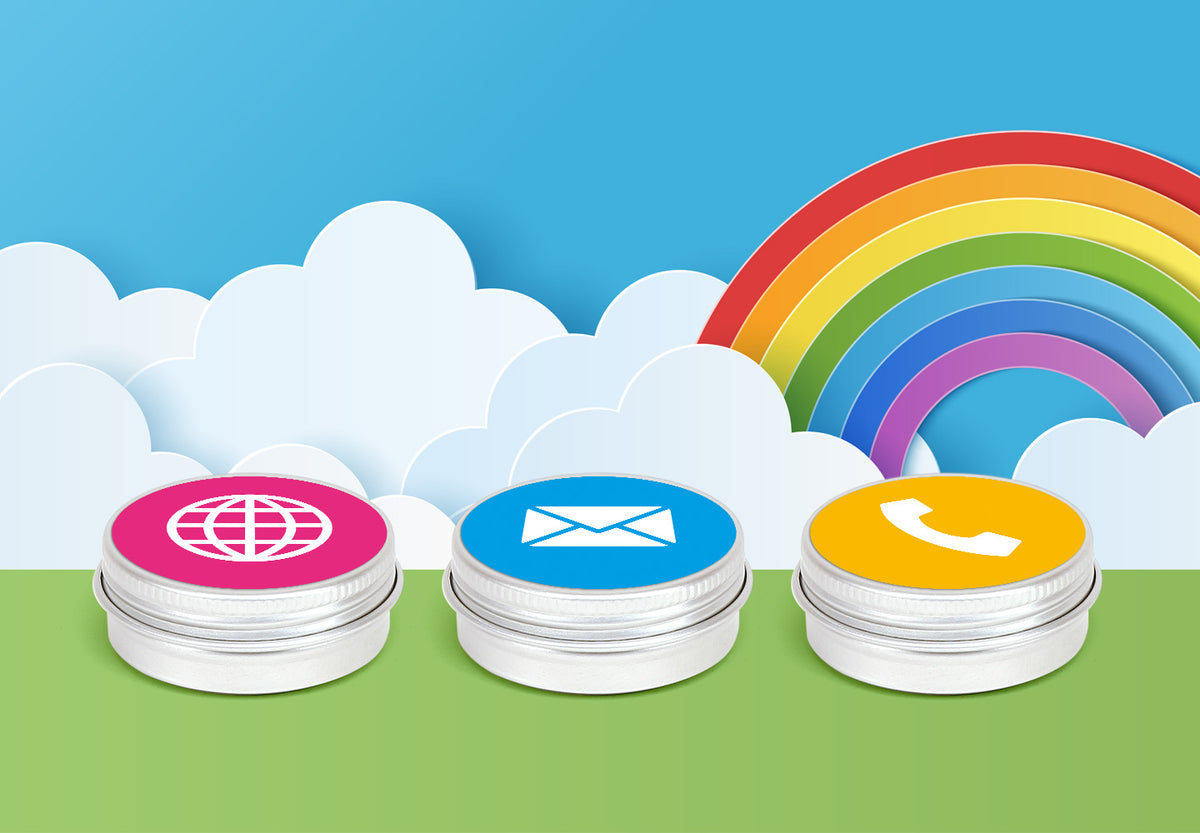 Three silver aluminium screw lid tins with labels that have icons for the website, email and phone, sitting against a background of clouds and a rainbow.