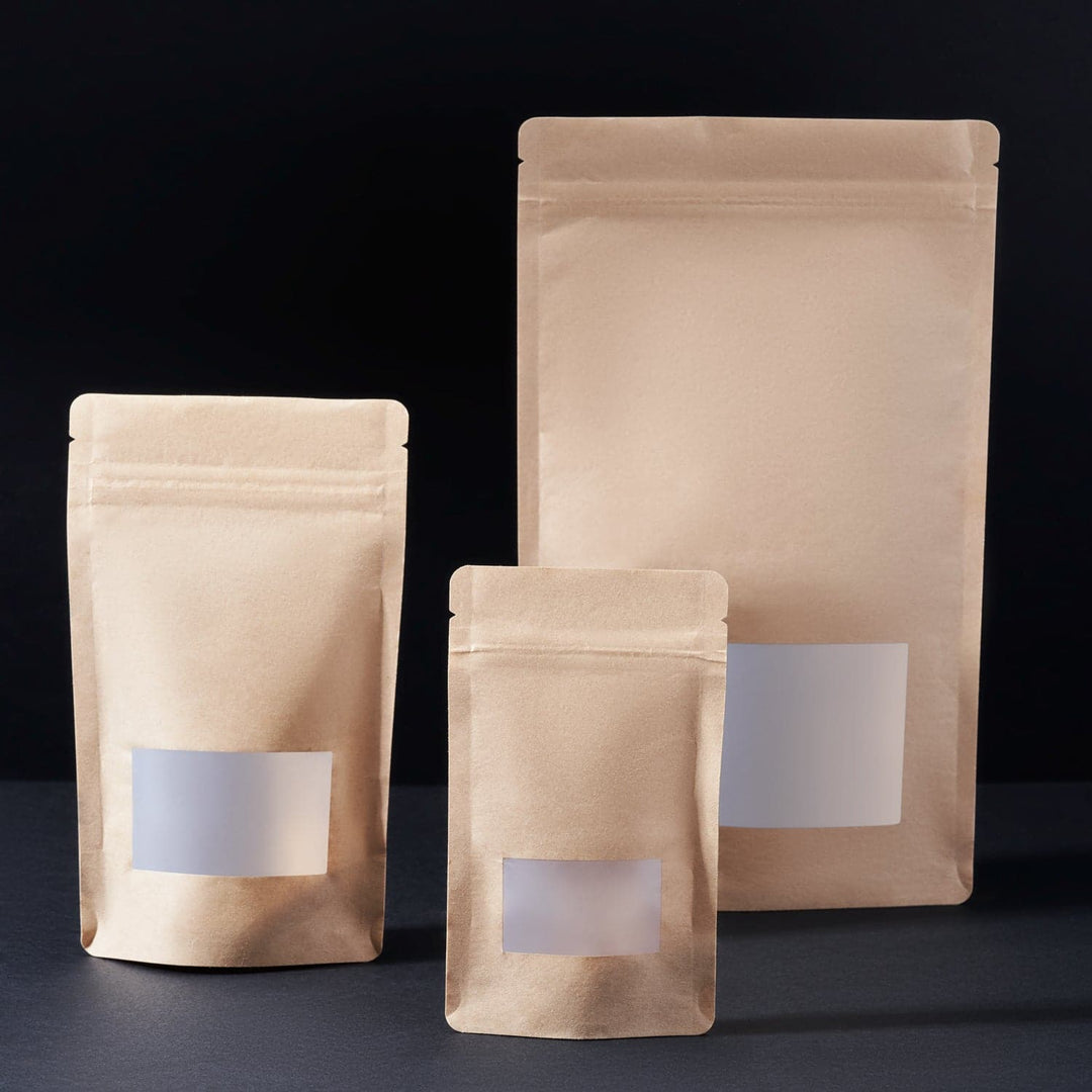 Stand Up Pouches with Window in three different sizes on a black background. 