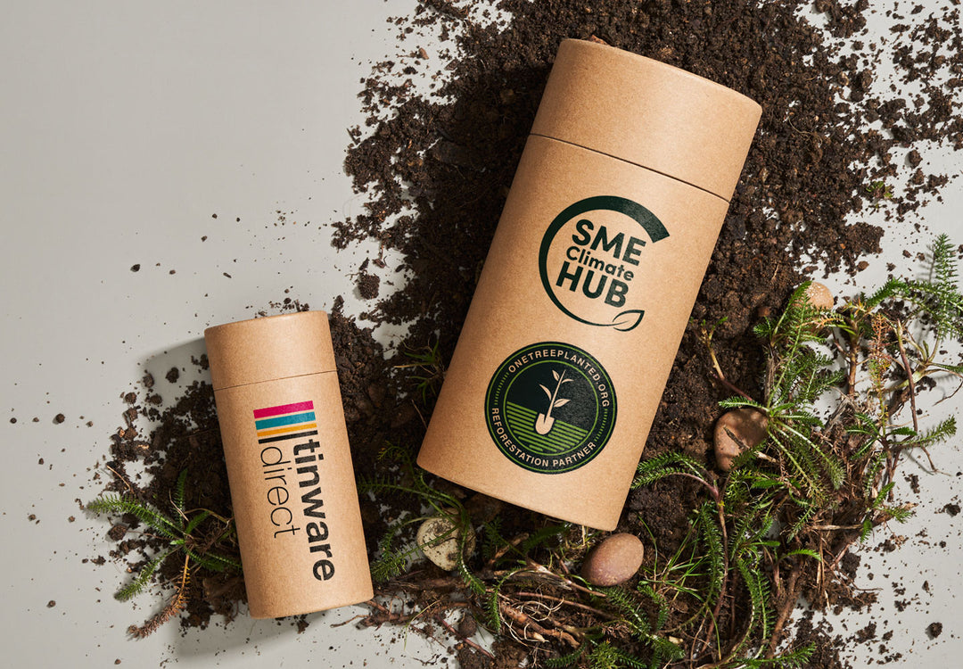 Two Tinware Direct branded cardboard tubes. One tube has the One Tree Planter Reforestation Partner logo and SME Climate Hub logo.