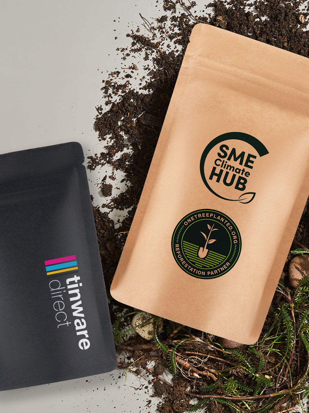 Printed home Compostable Stand Up Pouch Packaging resting on soil and a white background. 
