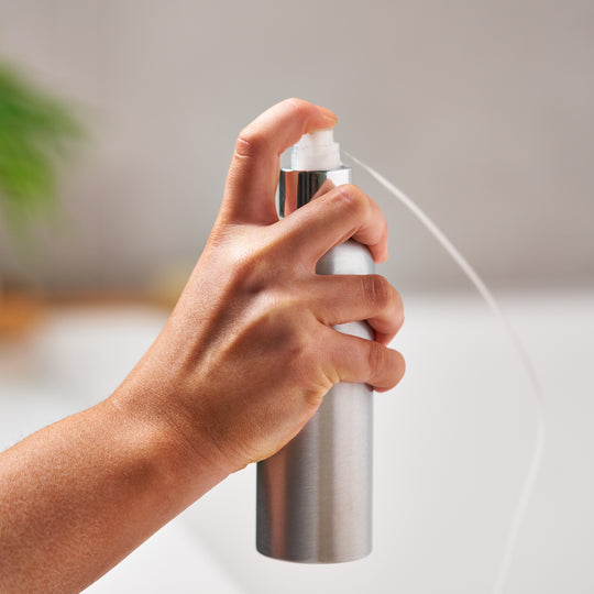 Cap sprayed when connected to silver aluminium bottle. 