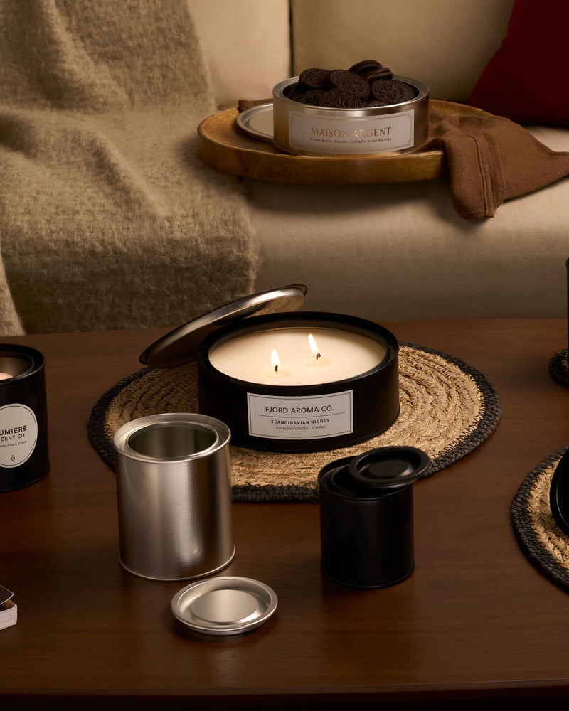 Lever lid tins containing candles and biscuits in a living room.