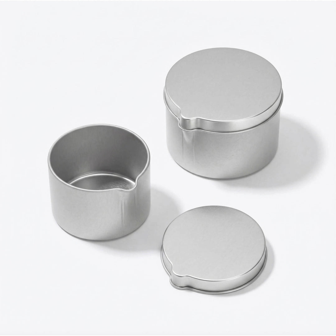 Two different silver seamless tins with pouring spouts.