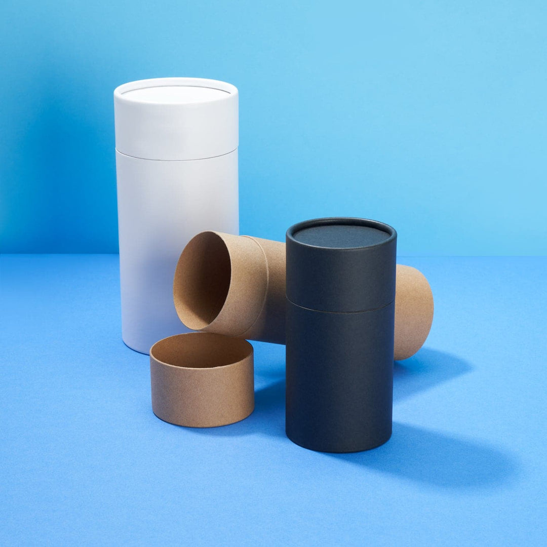 Three multipurpose cardboard tube packaging in white, brown and black