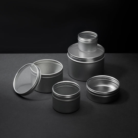 A collection of different sized silver slip lid tins with window lids.
