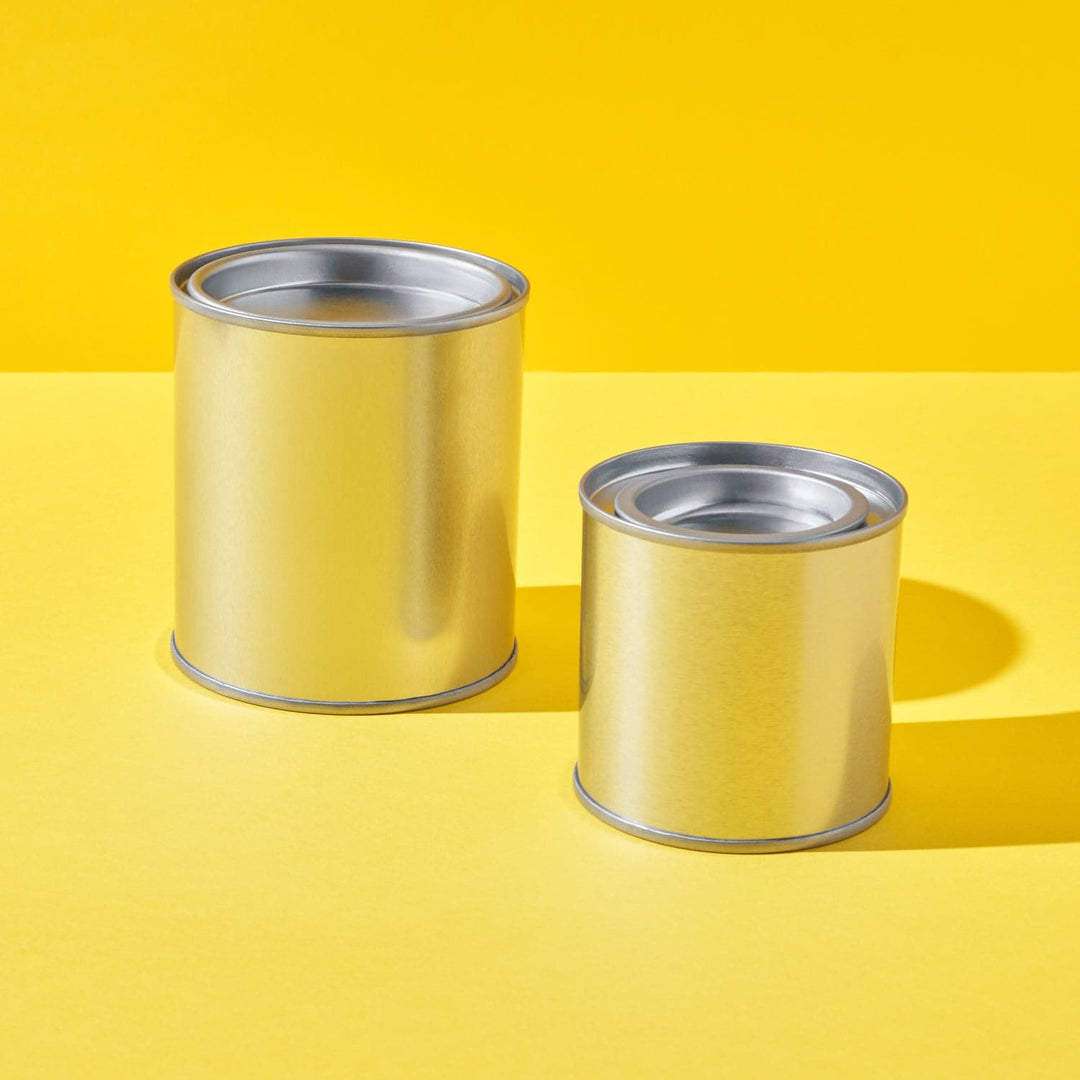 Two different sized small tins in a paint pot style in silver.