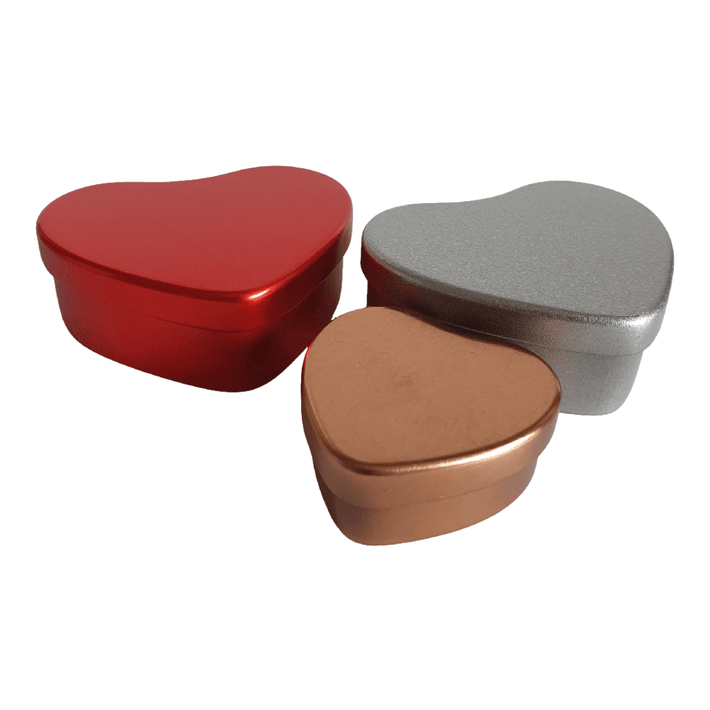 A collection of heart shaped tins in red, rose gold and silver.