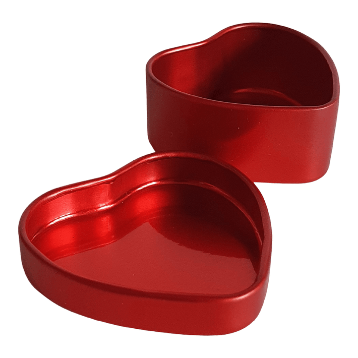 A red heart shaped tin with its lid off showing the inside.
