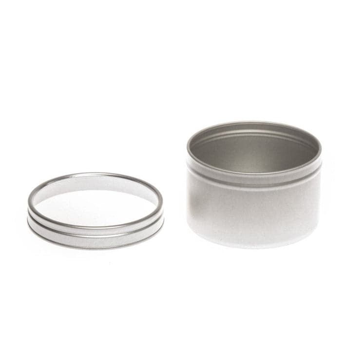 A round silver tin with a clear windowed slip lid with product code T0704W. The tin has its lid removed.
